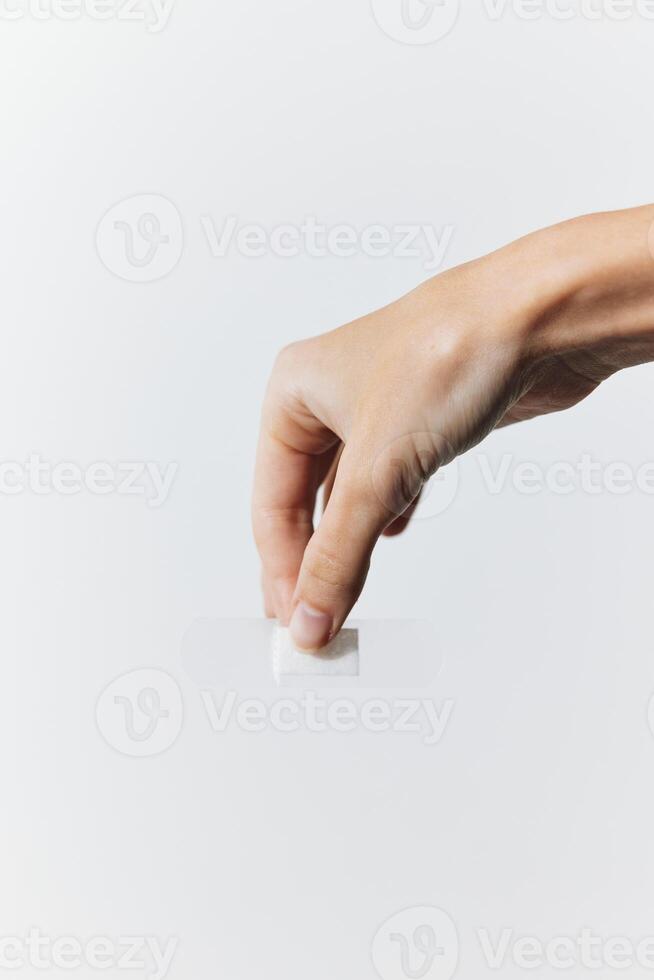 Hand holding paper with adhesive bandage on white background. healthcare concept. photo