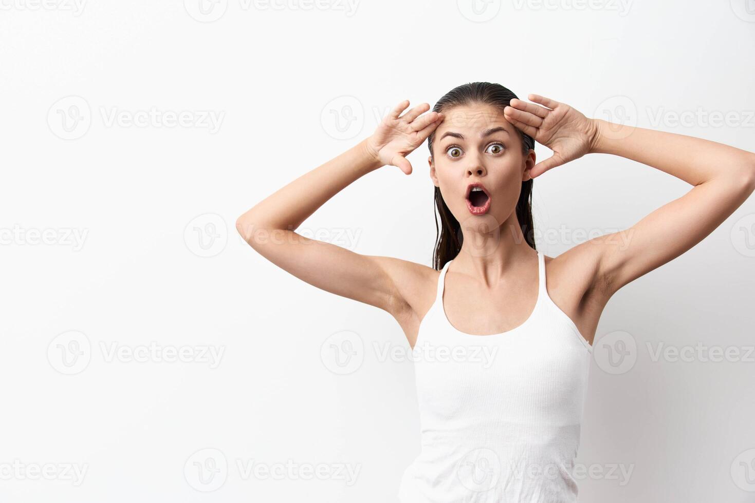 surprised young woman expressing shock and disbelief with wide eyes and an open mouth, hands on her photo