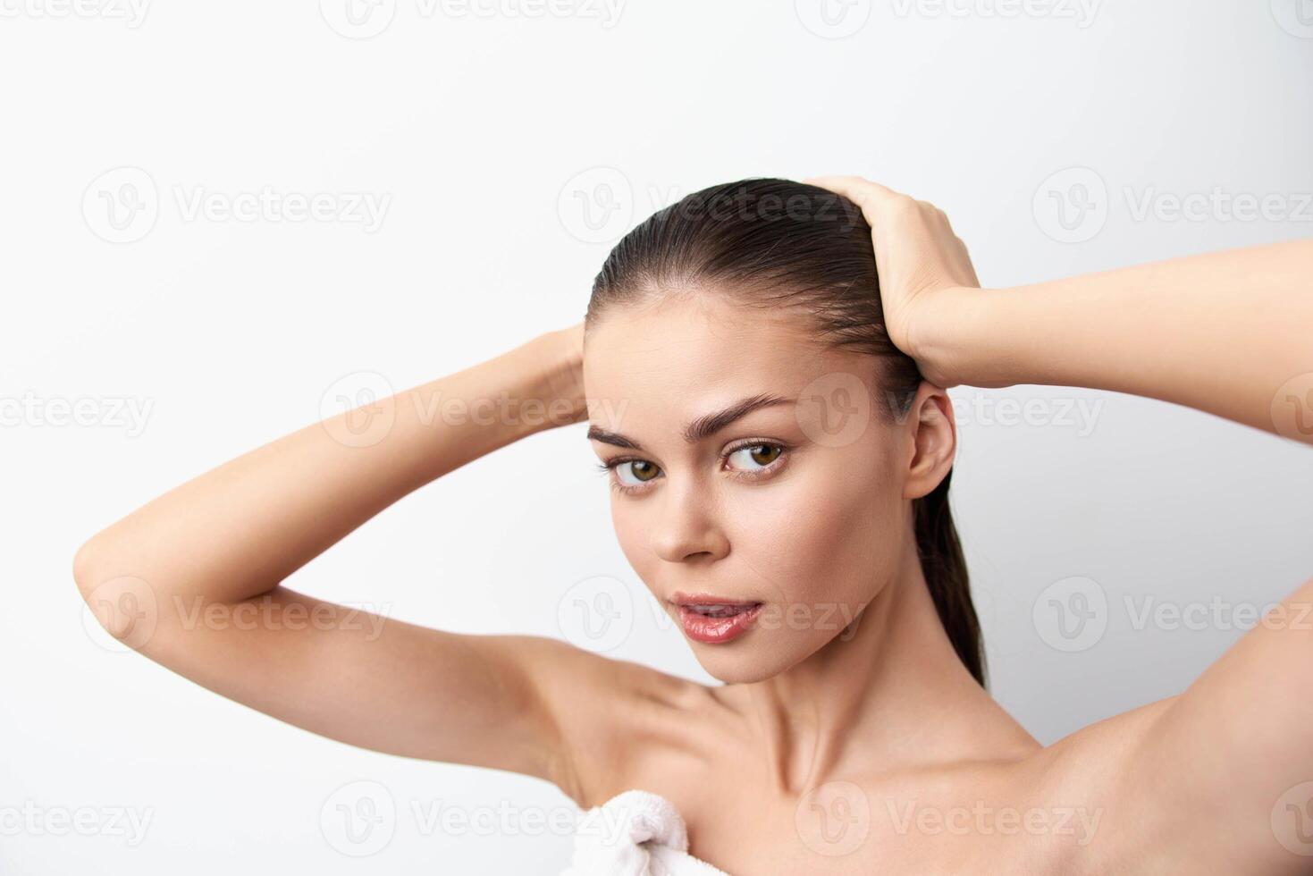 Close up portrait of a beautiful young woman with straight, glossy hair, looking directly at the photo
