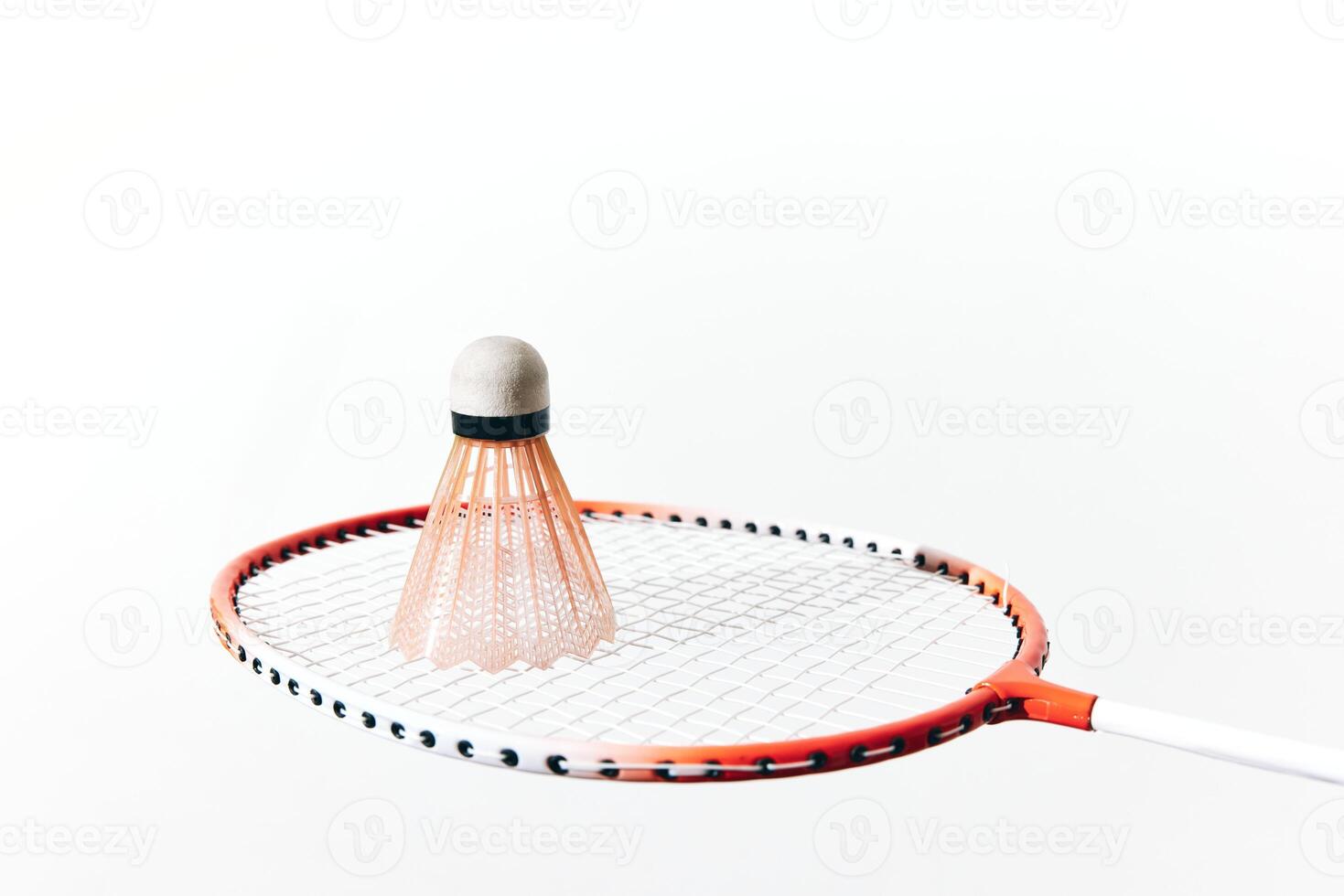 Badminton racket and shuttlecock on white background, shuttlecock hitting the racket. a close-up photo