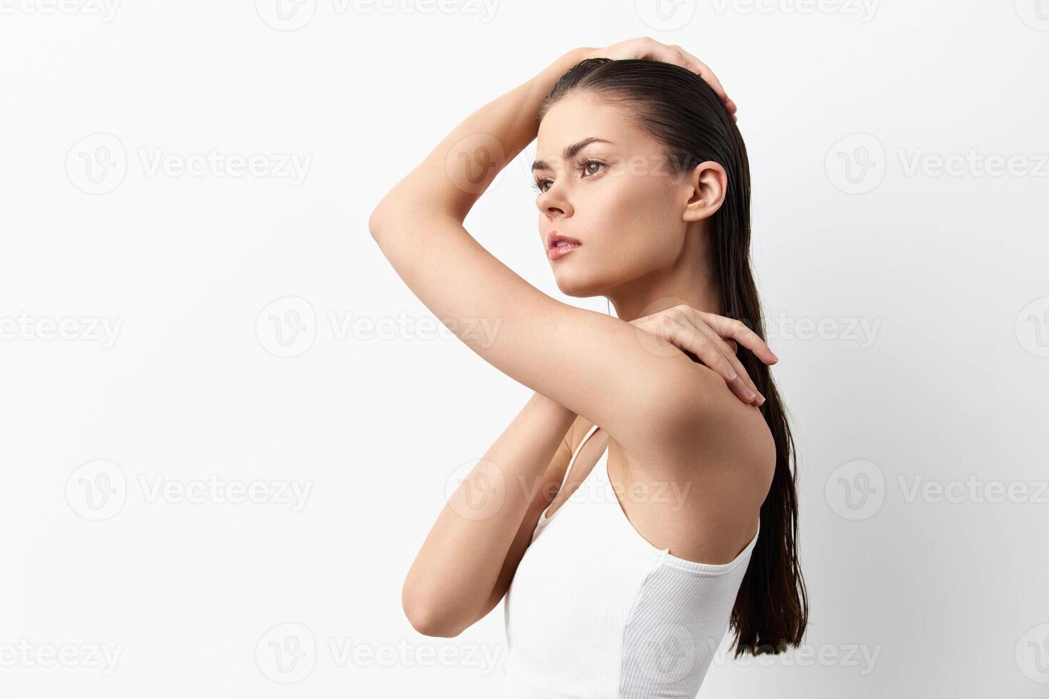 A side profile of a young woman with long, straight hair, dressed in a simple white top She exudes photo