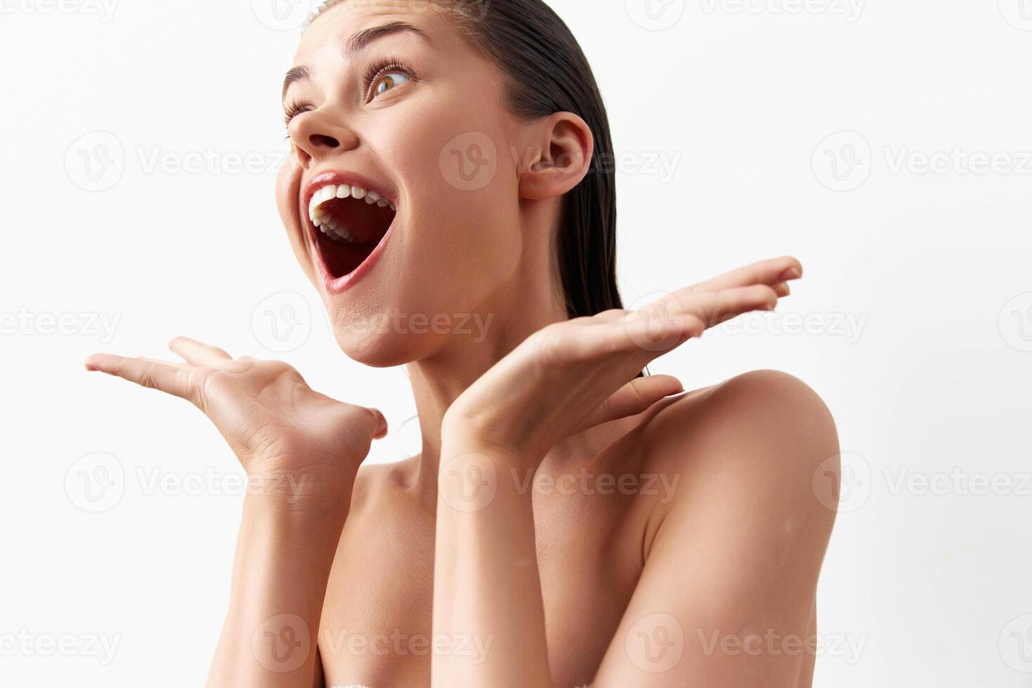 A young woman with a joyful expression, showcasing her excitement and happiness She has wet hair and photo