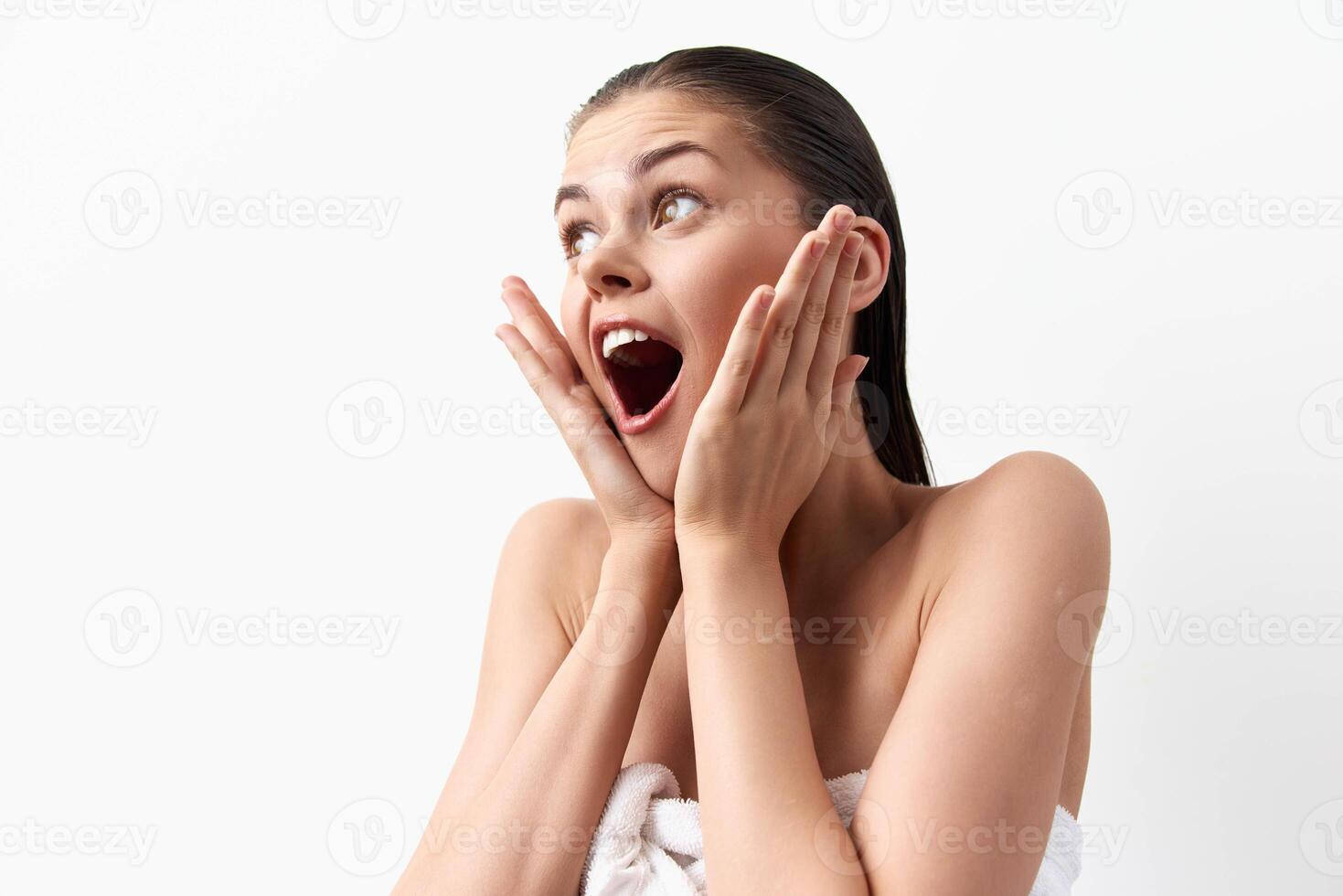 surprised young woman with an open mouth shows excitement and happiness She has long hair and wears photo