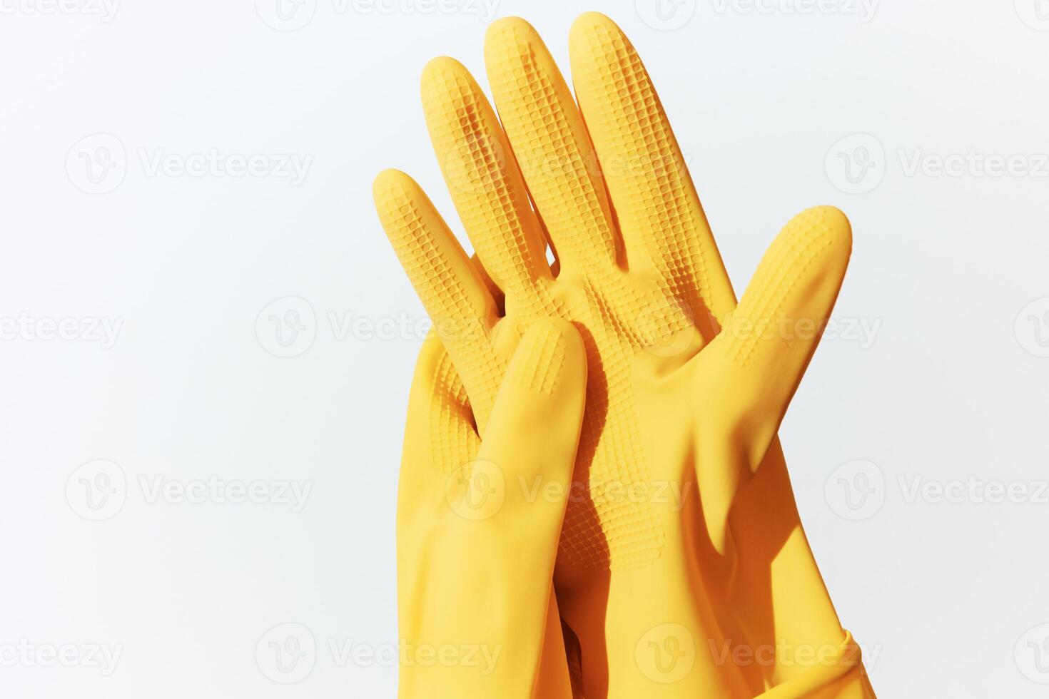 Rubber gloves in yellow color on a white background. 3d ing. photo