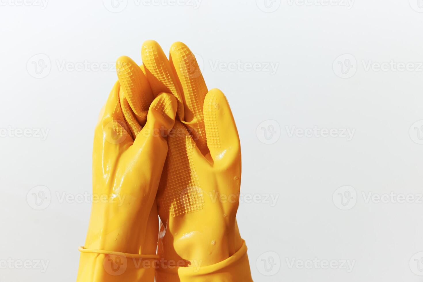 Yellow rubber gloves isolated on white background. pair of cleaning gloves with copy space for text photo