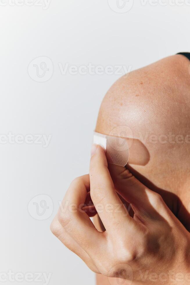Woman wrapping white bandage around her arm and shoulder. medical treatment concept. healthcare and photo