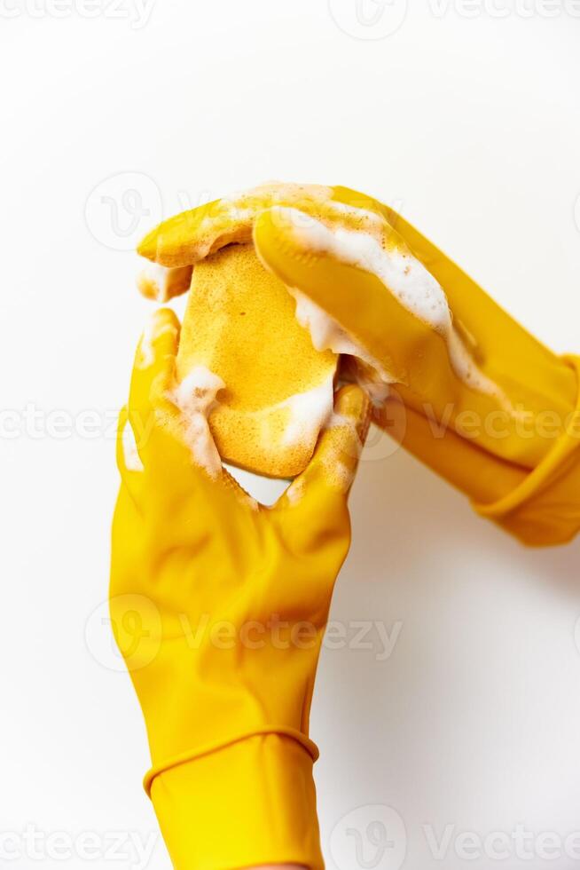 Person holding food in yellow rubber gloves. close-up shot of hands with a piece of food. kitchen photo