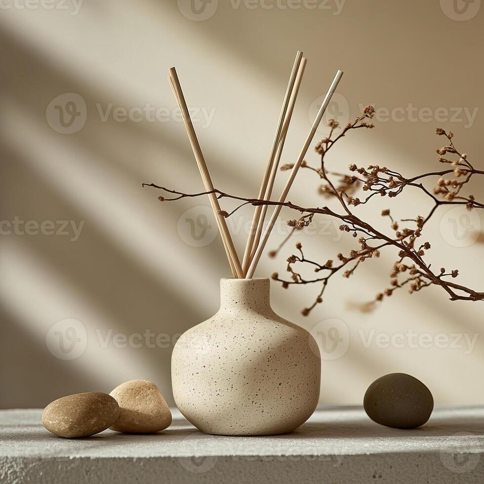 A minimalist vase with natural reeds and stones on a neutral surface, creating a calming home decor atmosphere. photo