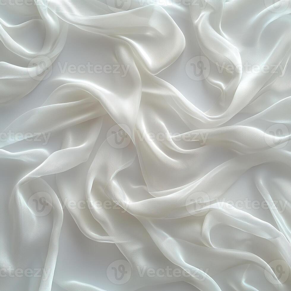 Delicate white silk fabric draped elegantly on white background, creating a soft and flowing texture. photo