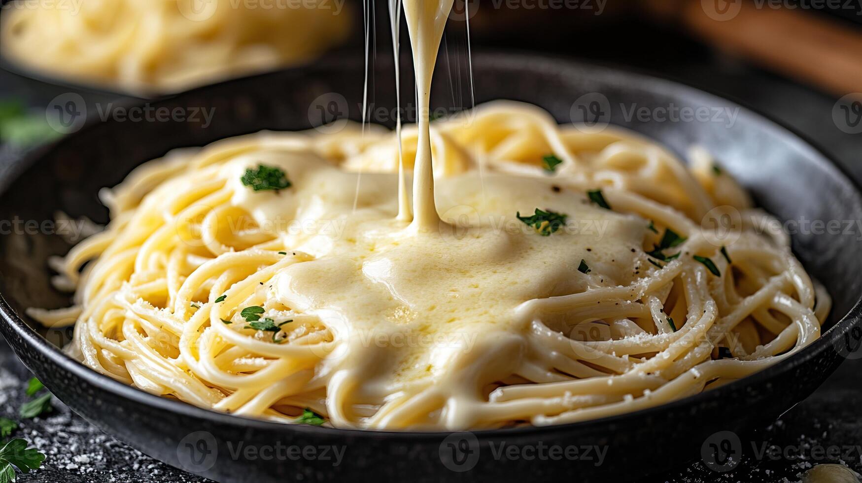 Creamy cheese sauce drizzled over fresh pasta in a rustic bowl. photo