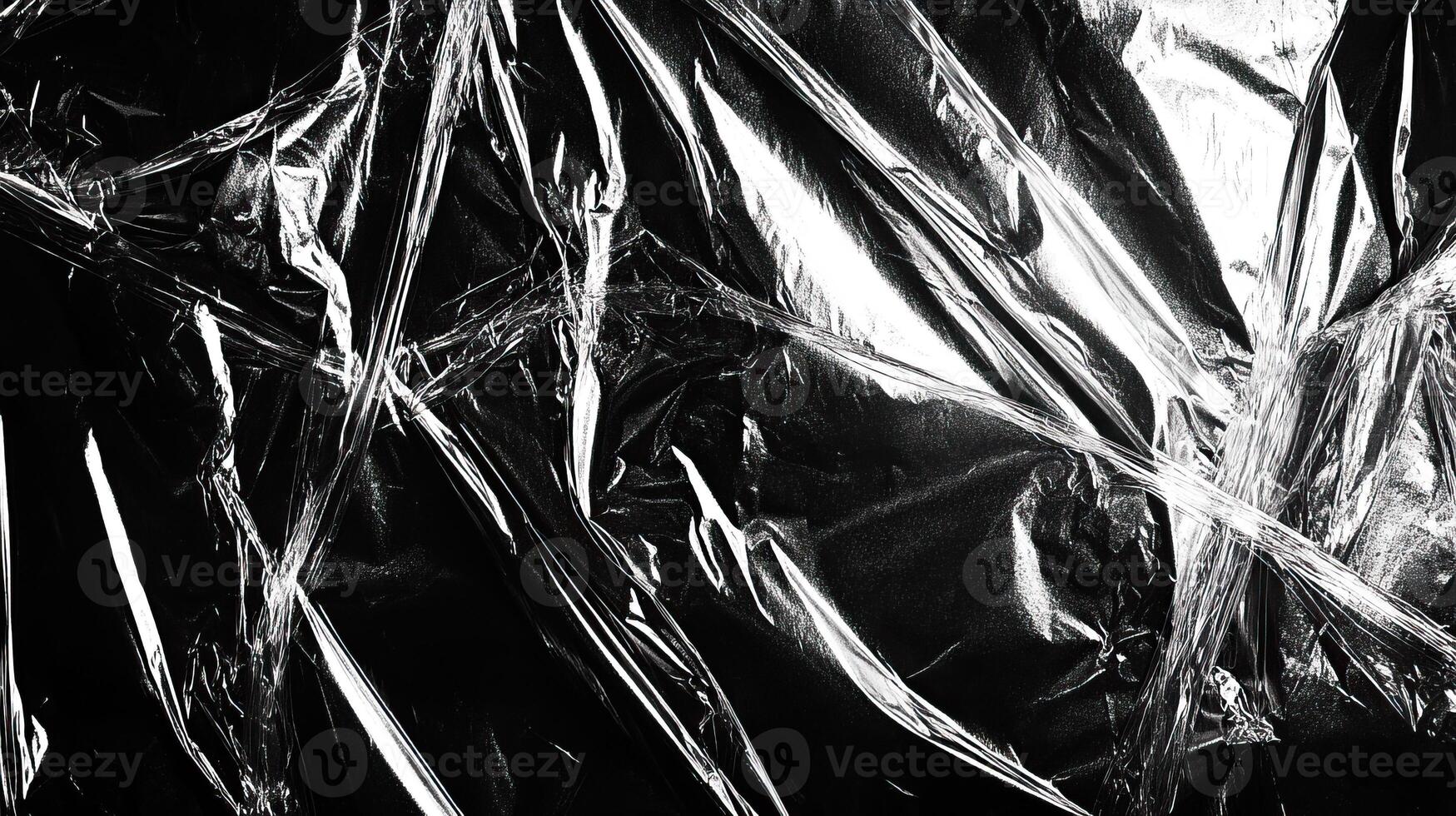 Textured black plastic wrap creating an abstract layered effect, perfect for backgrounds and design projects. photo