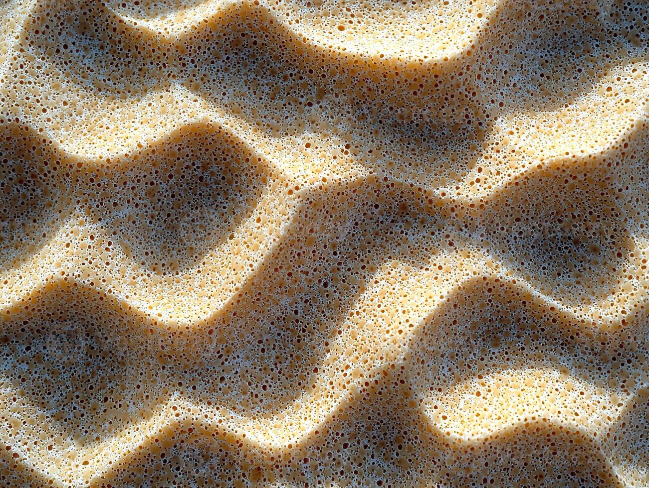Textured close-up of sand surface, showcasing natural patterns and grain in sunlight. photo