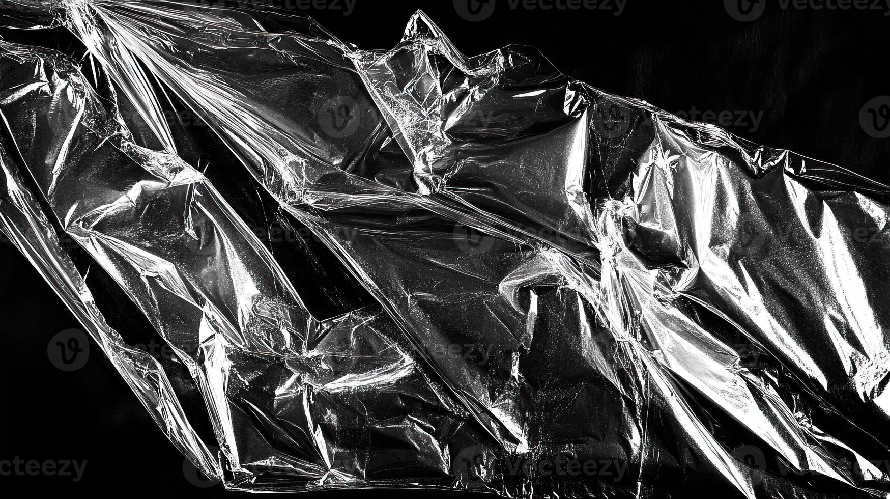 Shiny plastic sheet crumpled on a dark background, creating an abstract texture and pattern. photo