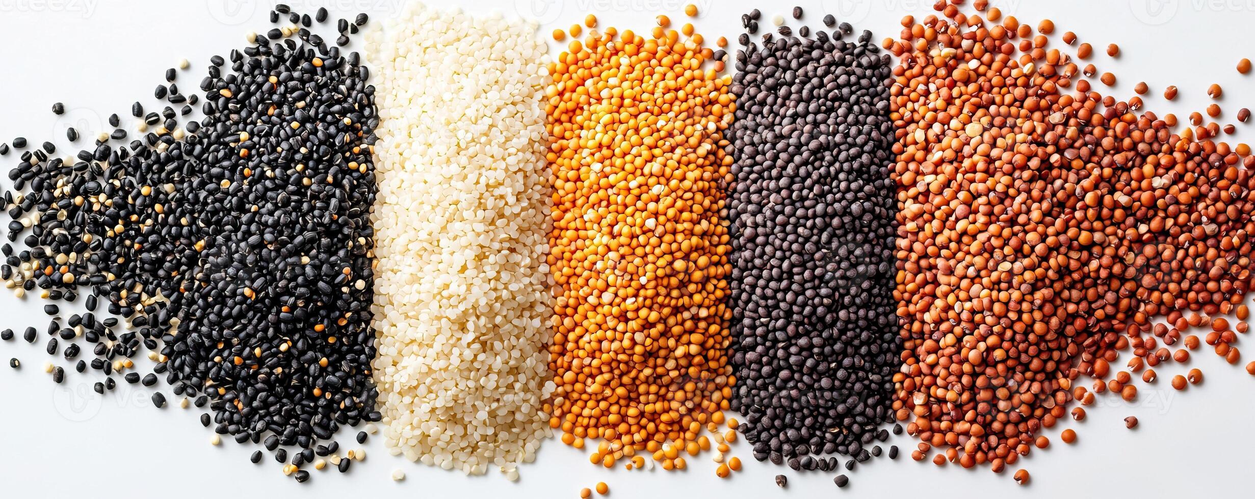 Colorful variety of uncooked grains and seeds arranged on a white background. photo