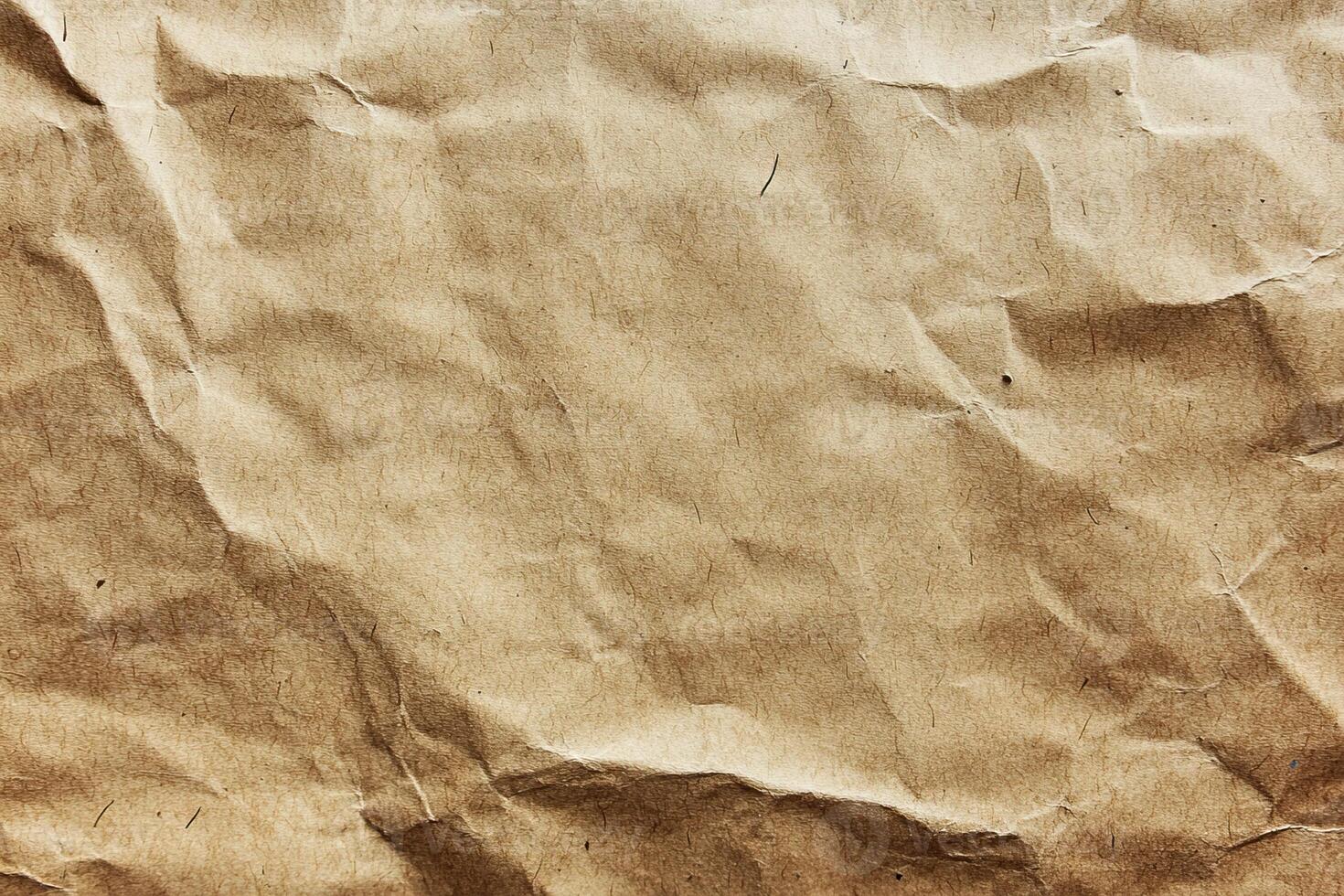 Textured, crumpled brown paper creating a rustic, vintage backdrop. photo