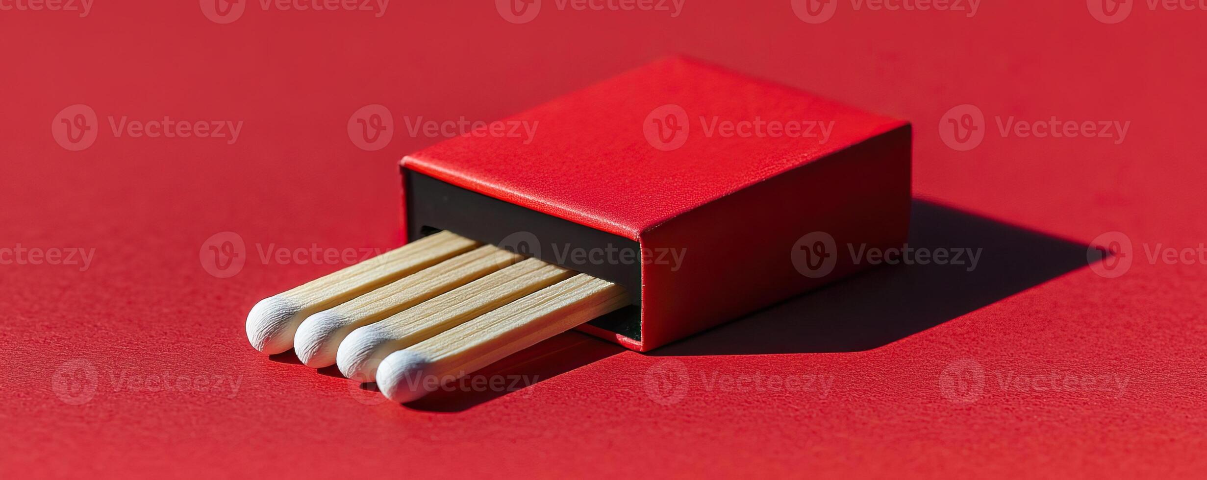 Minimalist matchbox on red surface, vibrant contrast, modern design photo