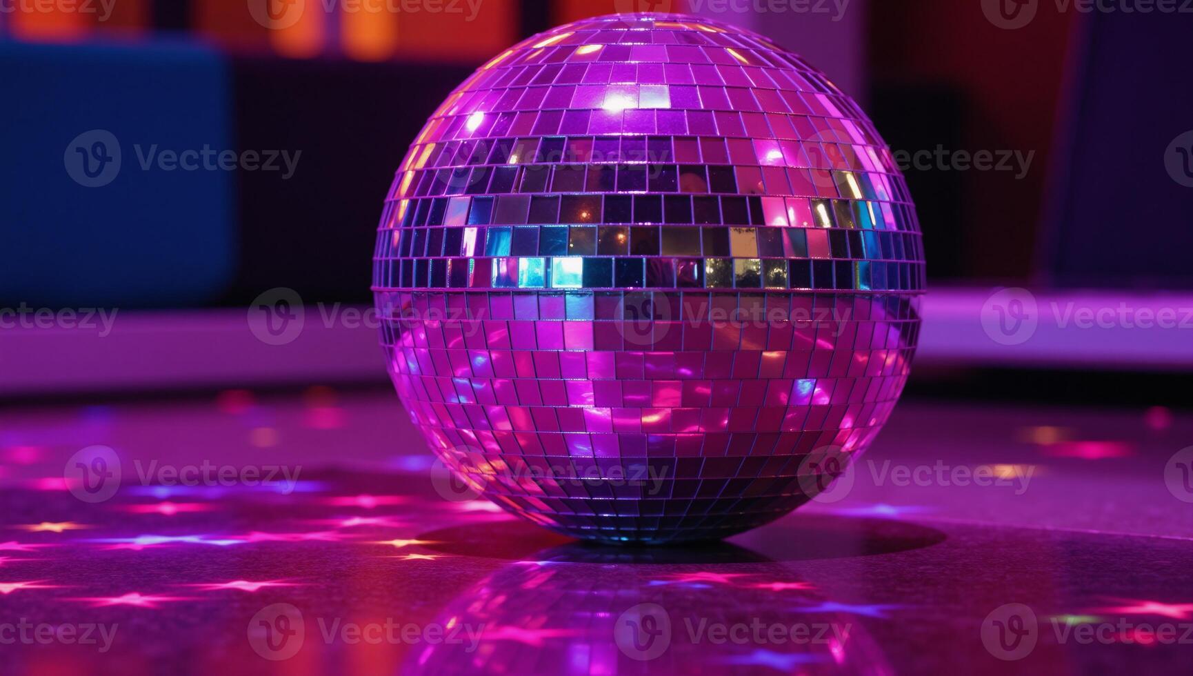 A neon disco ball surrounded by pink purple party lights illuminates a vibrant dance scene photo