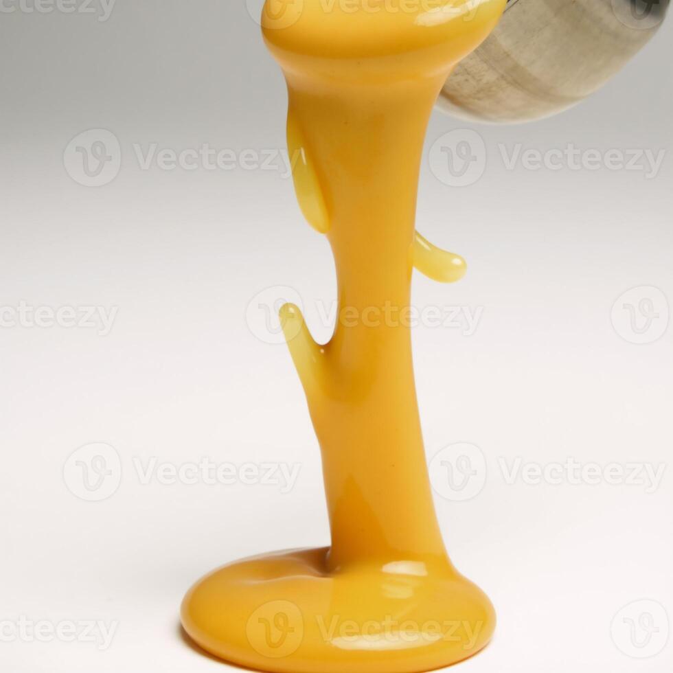 Molten cheddar creates an isolated form through dripping and splattering photo