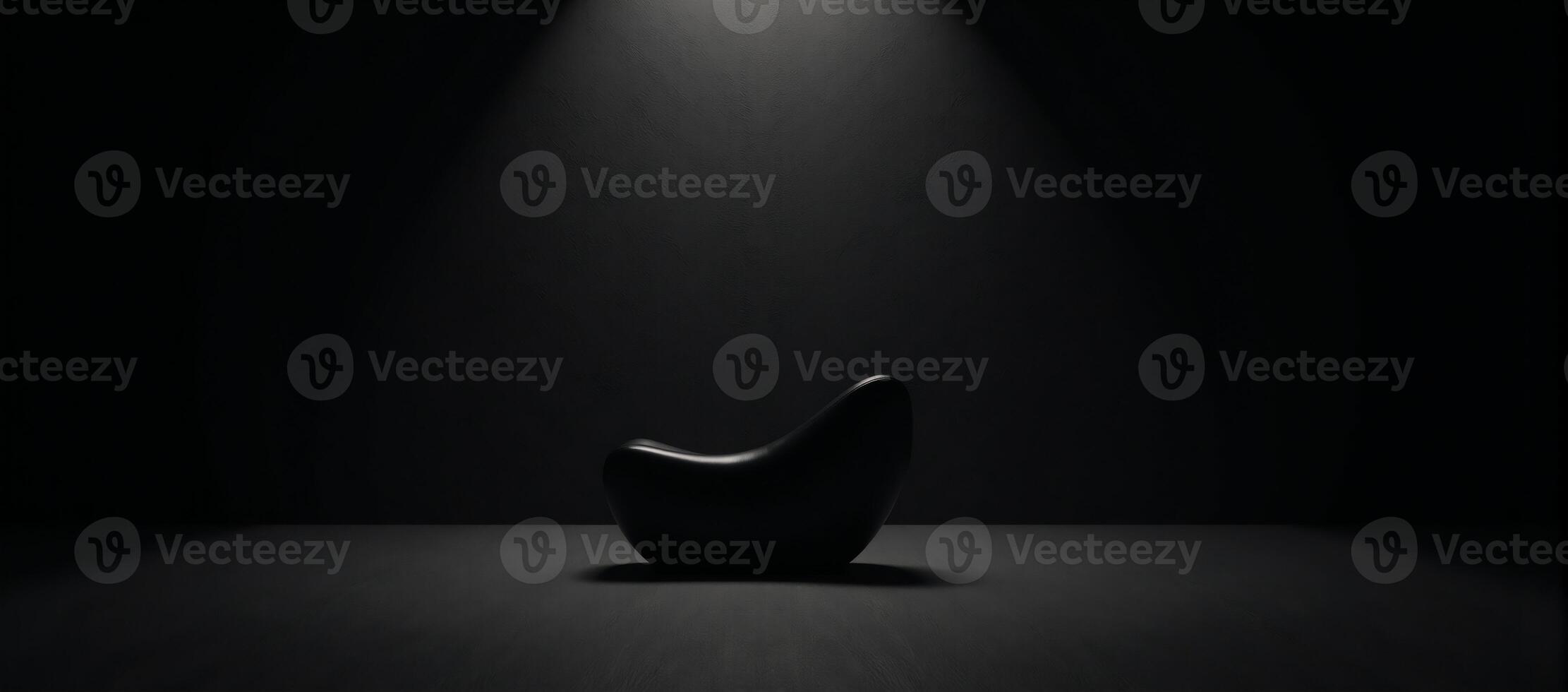 A darkened studio gallery highlights an abstract product showcased within an empty textured room setting photo