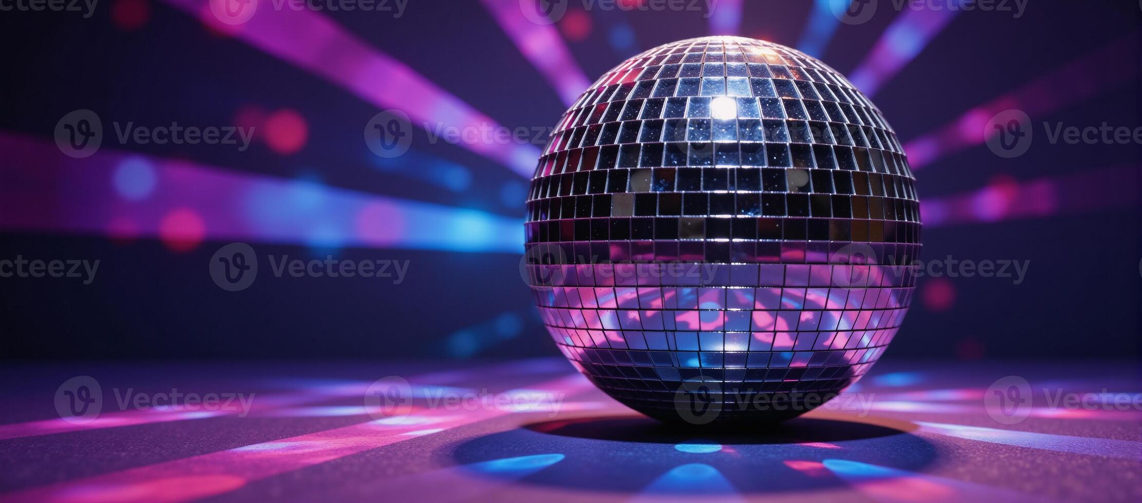 A disco ball shines against an abstract backdrop of colored rays and light effects Purple Pink Blue photo
