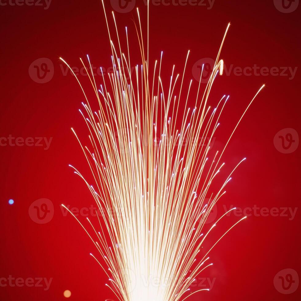 Fireworks illuminate against a striking red backdrop photo