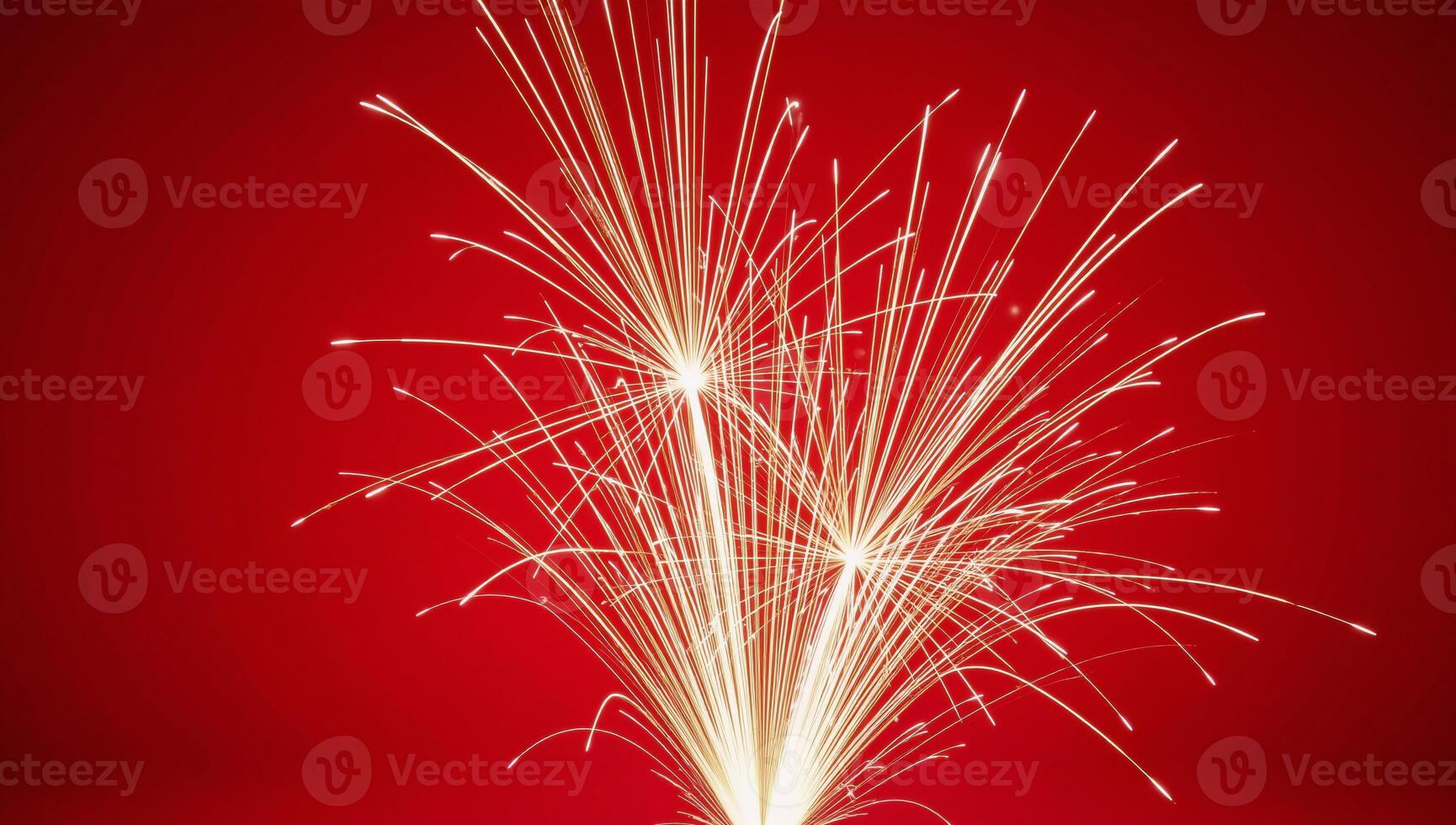 Fireworks illuminate against a striking red backdrop photo