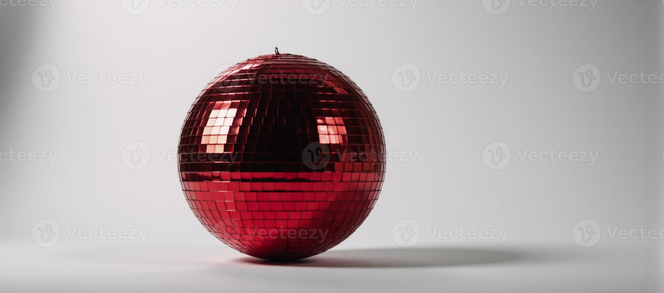 Isolated red disco ball glows against blank canvas backdrop photo