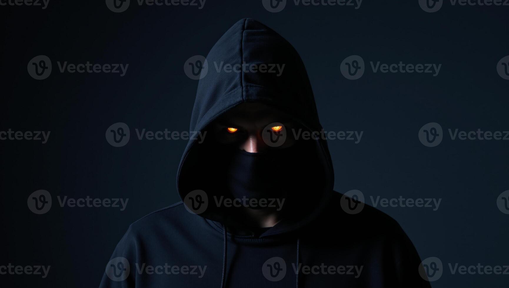 Halfbody shot of terrifying blackhooded figure with glowing orange eyes lurking in shadows photo