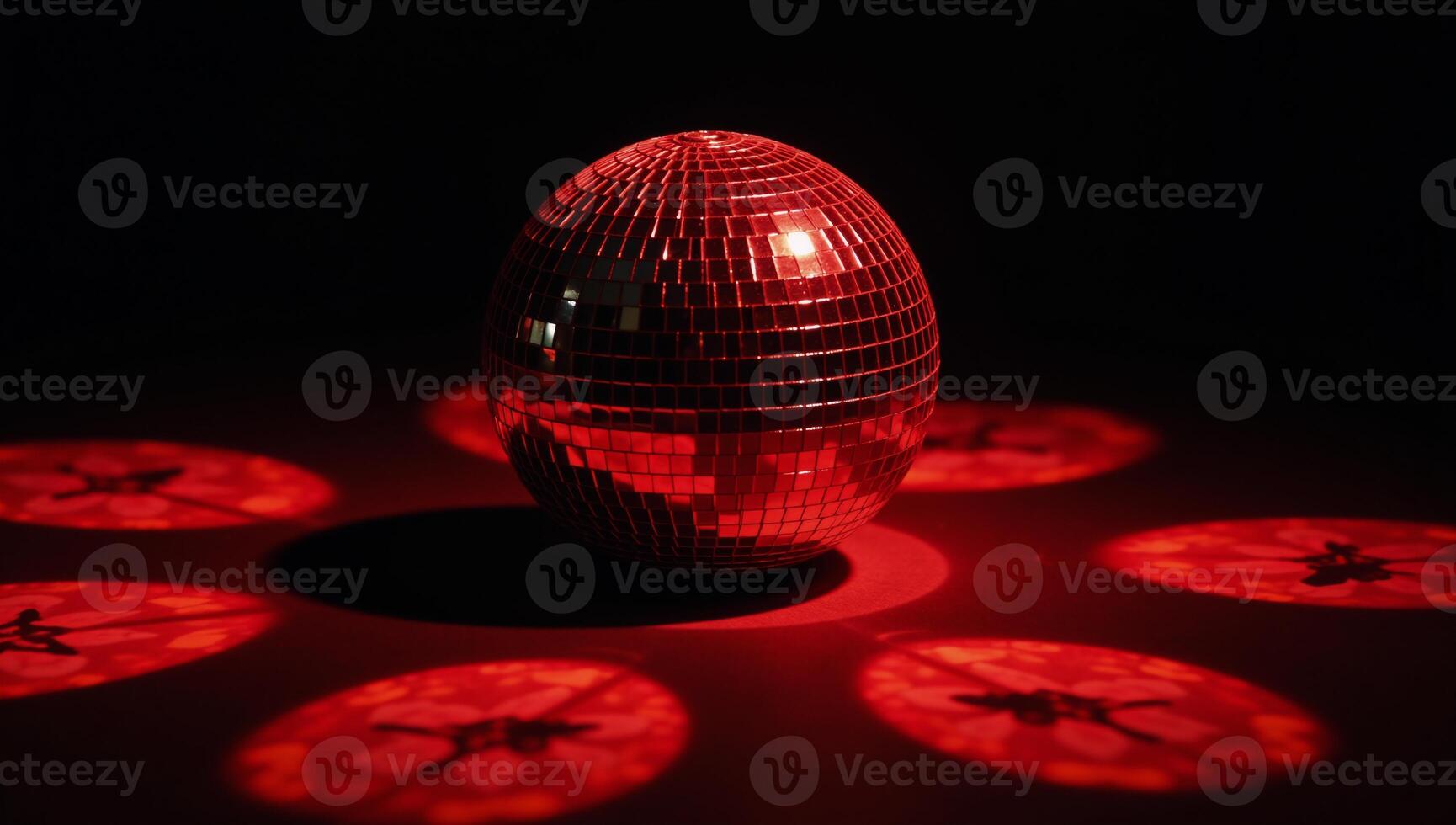 A shimmering red disco ball reflects light against an empty backdrop symbolizing a festive and lively atmosphere photo