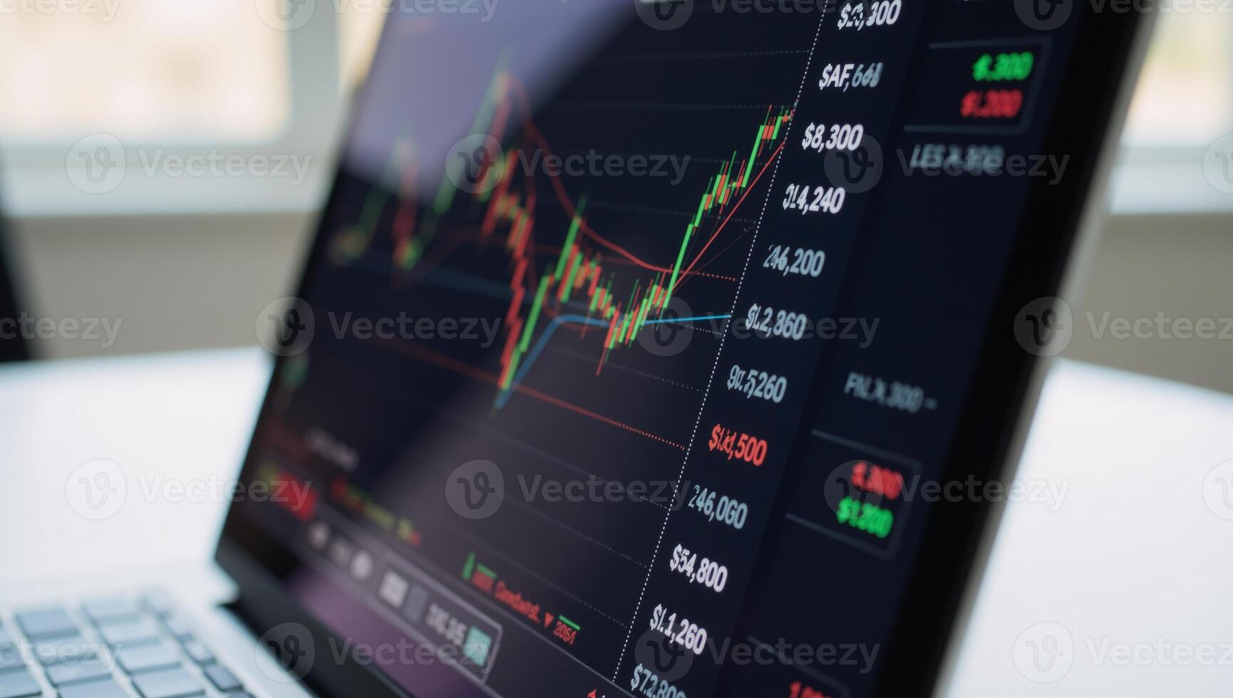 A laptop screen displays a stock market graph with financial data related to trading and investments photo