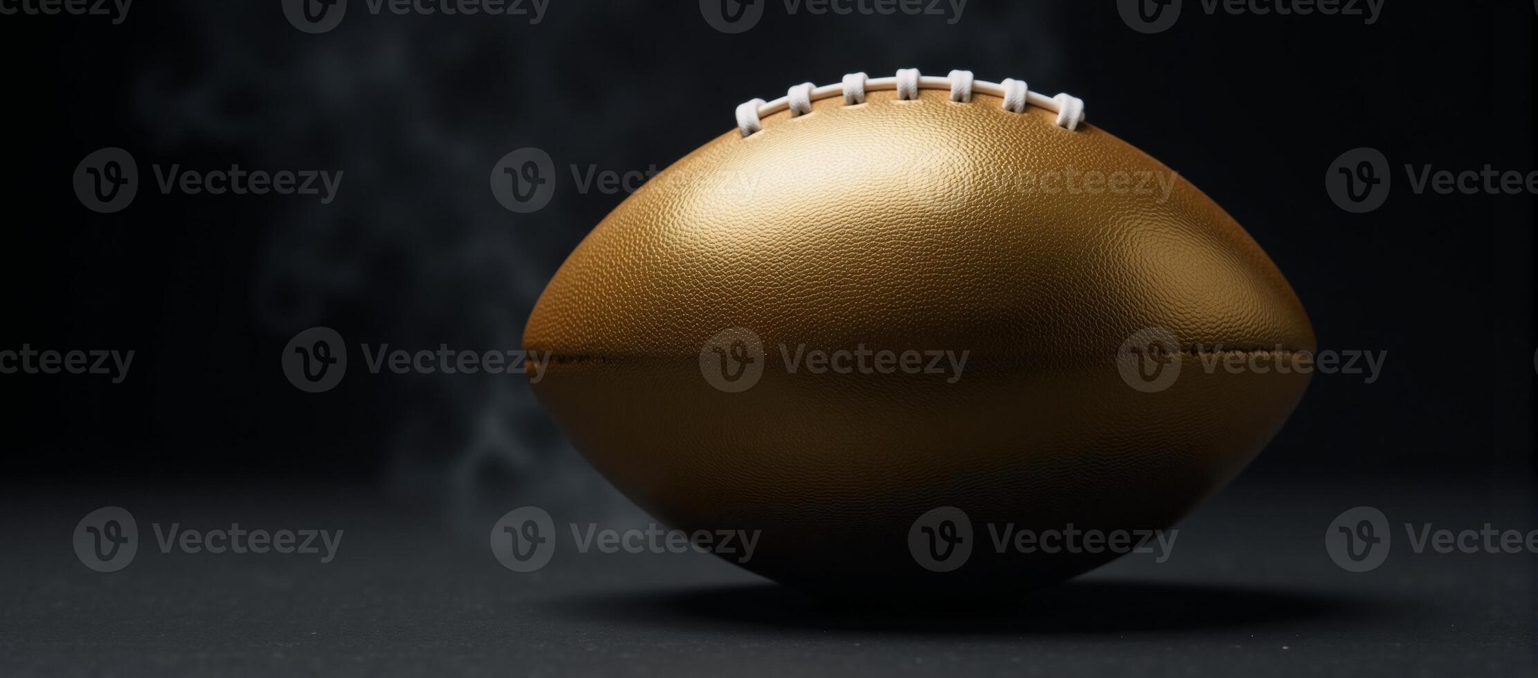 Goldplated football laces shine on an officialsize ball amidst a foggy backdrop creating a sense of championship games tension photo