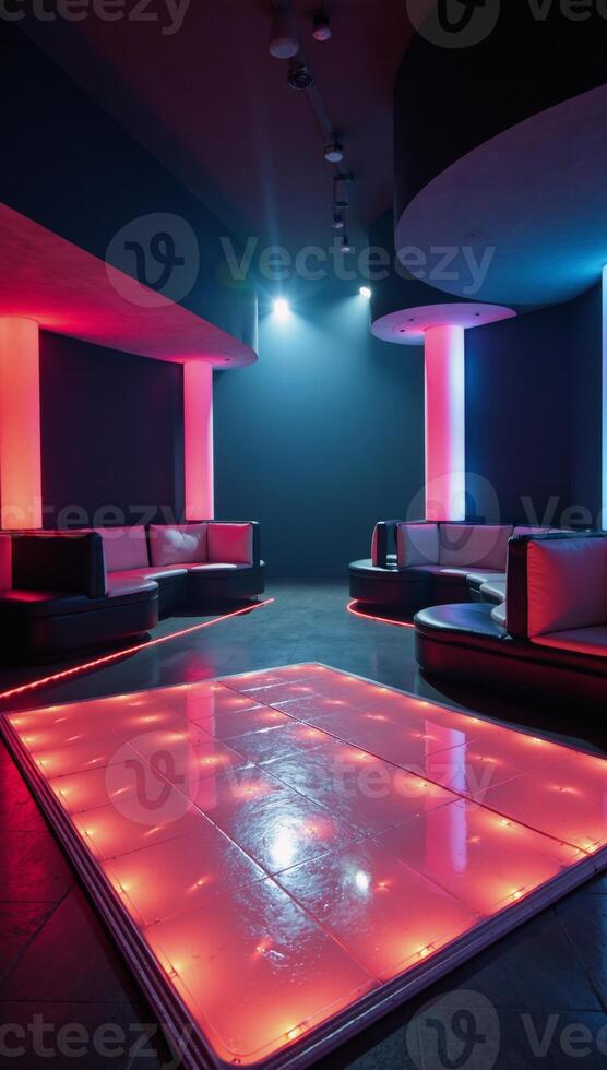 A highend futuristic club featuring an illuminated dance floor glowing LED walls and lavish VIP areas photo