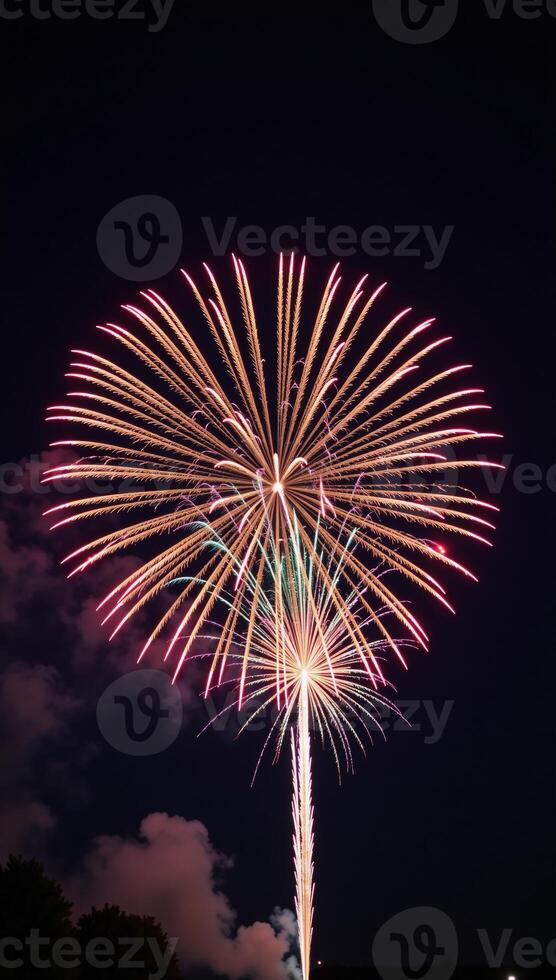 Night sky showcases a vibrant Fourth of July firework display over a bustling cityscape backdrop photo
