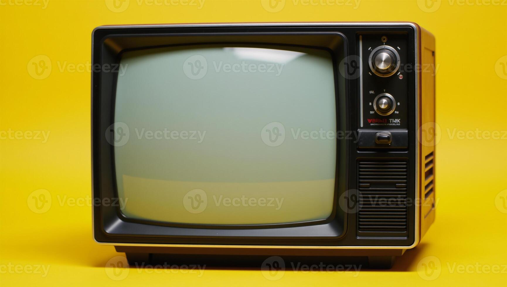 Old television on yellow background photo