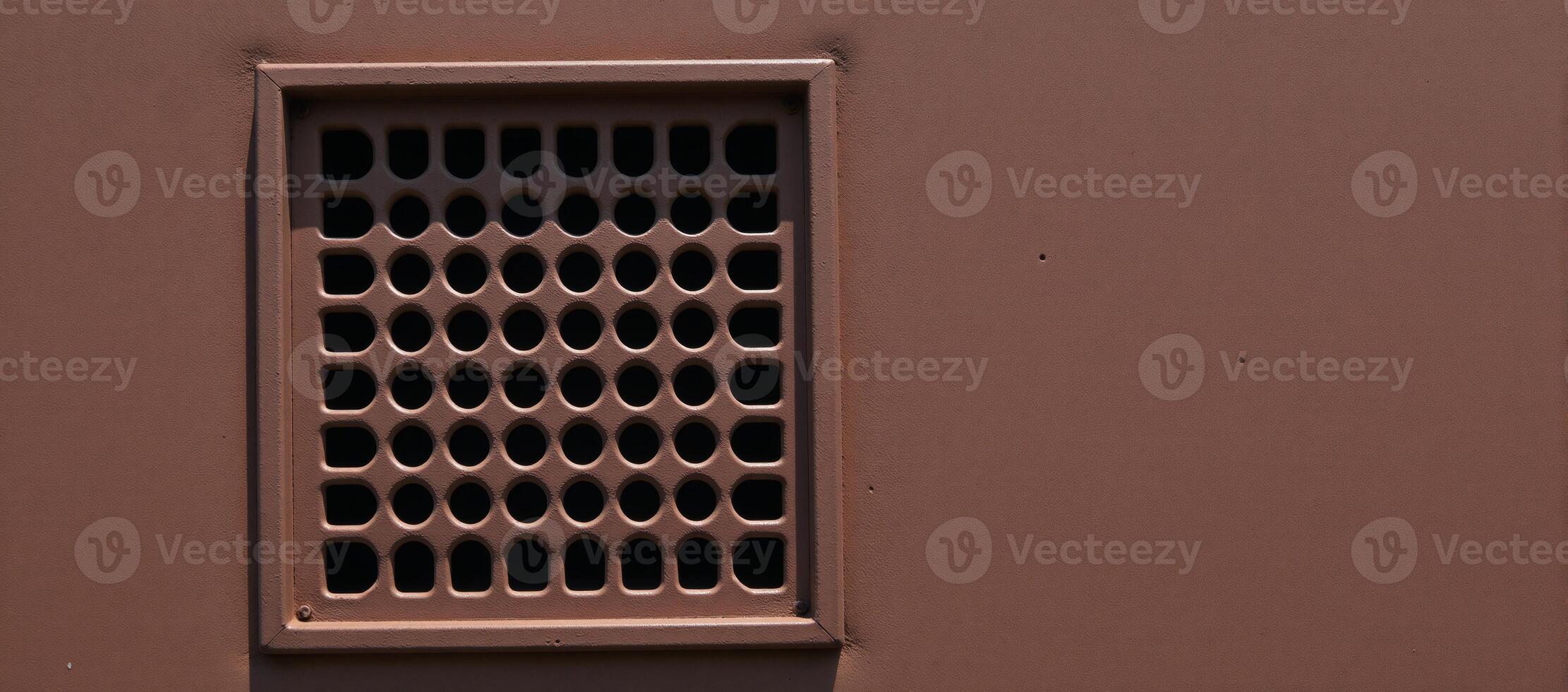 Rusty metal panel with rectangular vent circular hole pattern photo