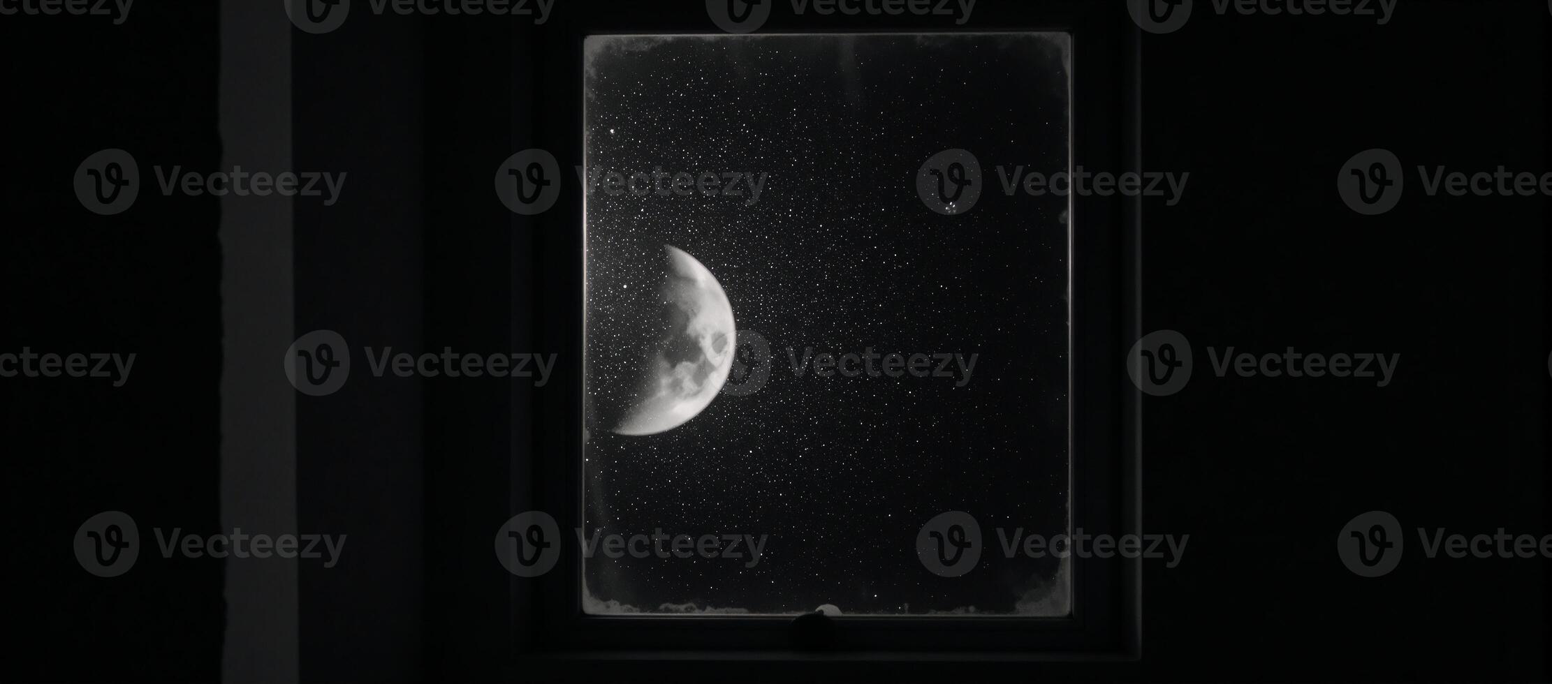 A halfmoon illuminates a dark room from an open window at night photo