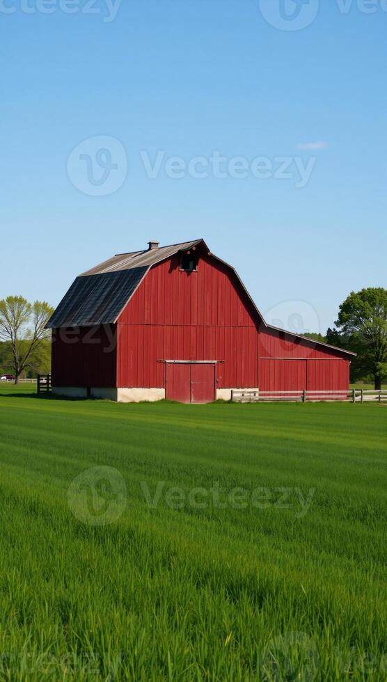 Closeup of a lush countryside scene featuring a double exposure of a vibrant red barn against verdant green fields set beneath a clear blue sky photo