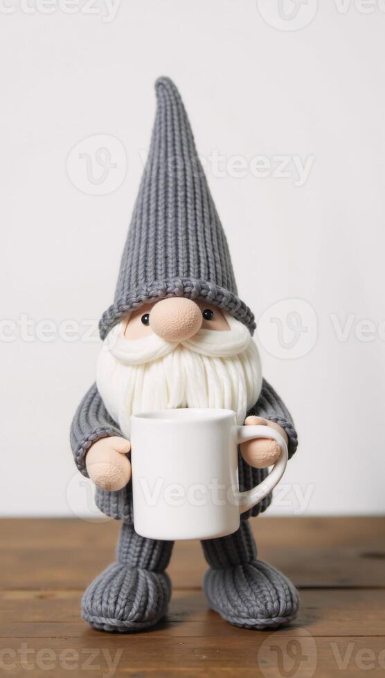 Adorable gnome figurine grayclad mugholding stands on wooded surface photo
