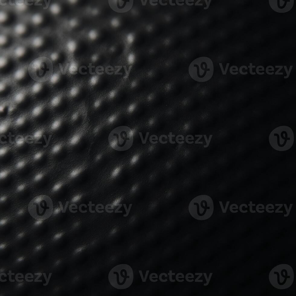 A black textured gradient background featuring an uneven matte surface photo