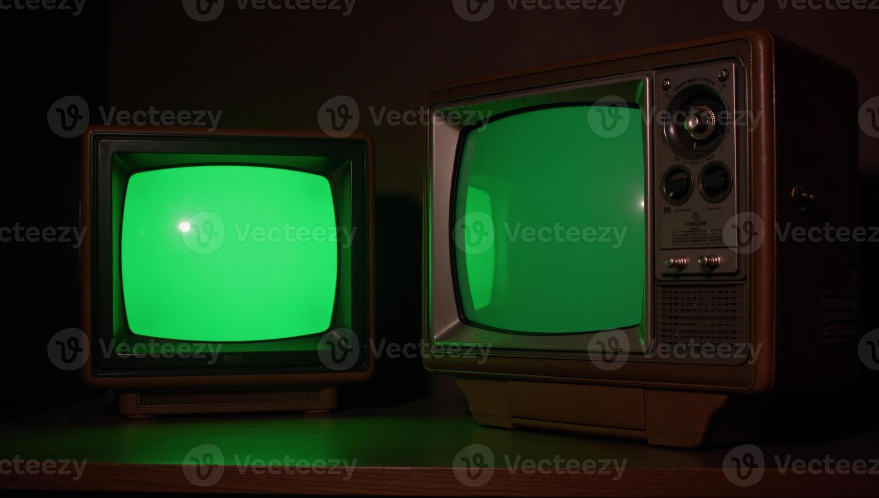 Dark room featuring vintage TV sets with emeraldhued screens photo