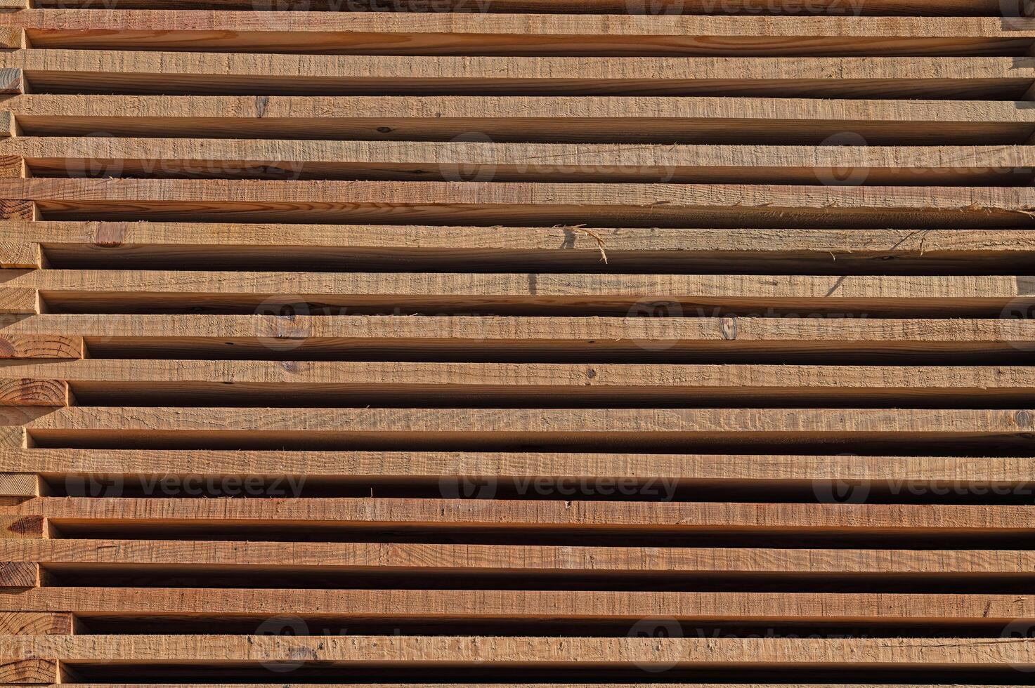 Wooden timber in the sawmill. Stacked wooden boards. photo
