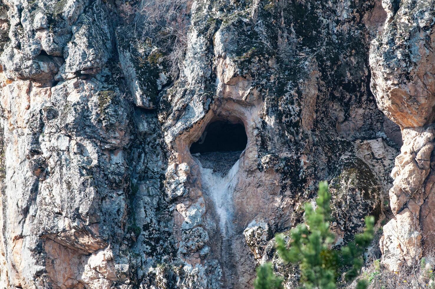 A cave with a hole in the side of it photo