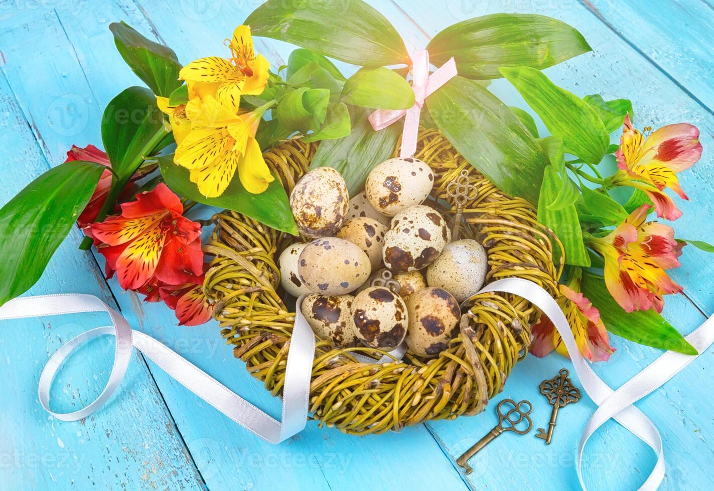 Spring background. Bouquet of flowers on a wooden background and a nest with eggs. spring photo
