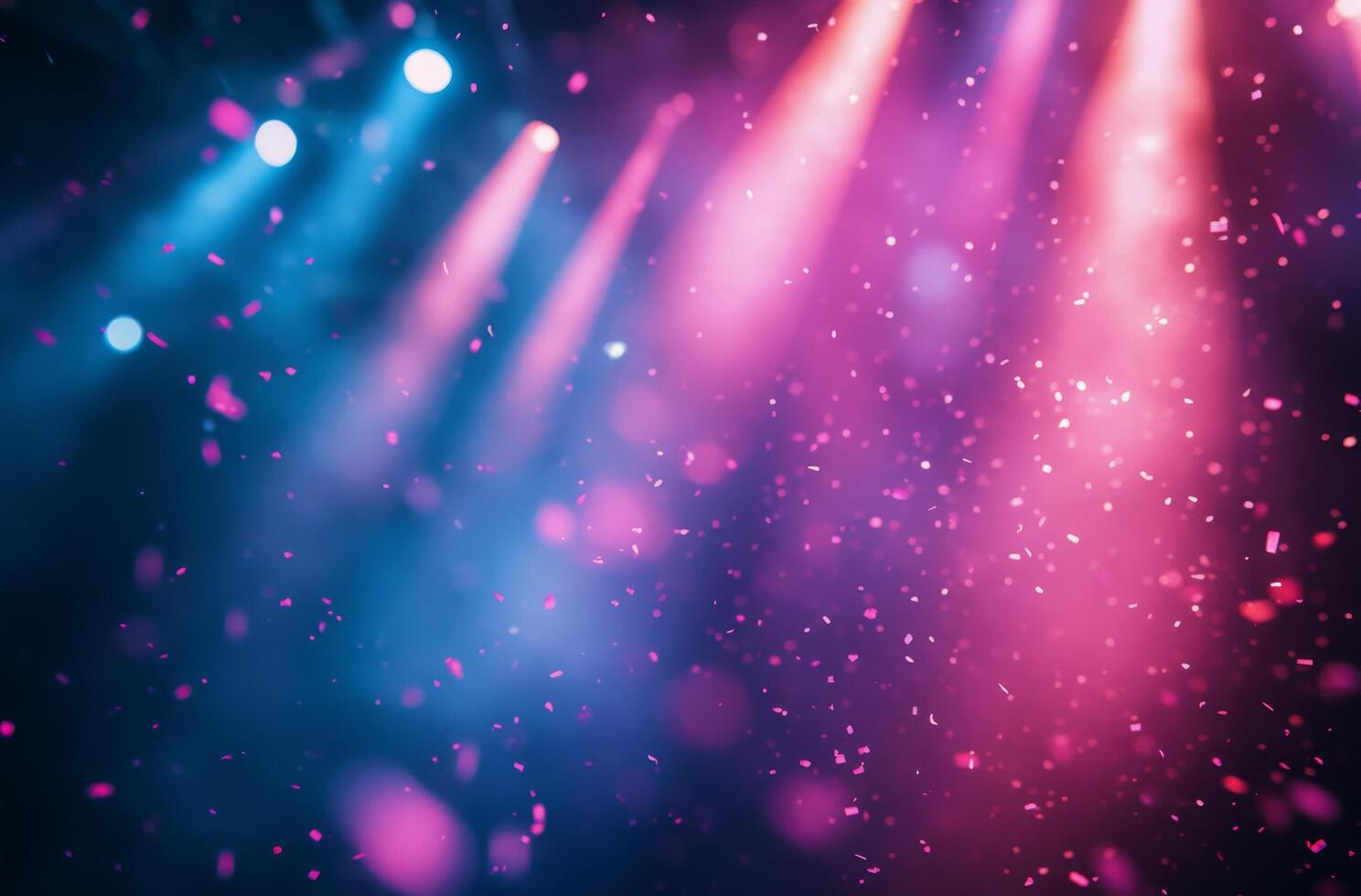 Colorful confetti shower under vibrant stage lights during a lively celebration photo