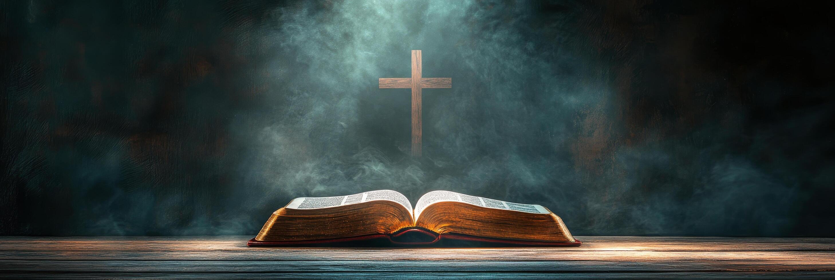 An open Bible resting on a wooden surface with a cross illuminated by soft light photo