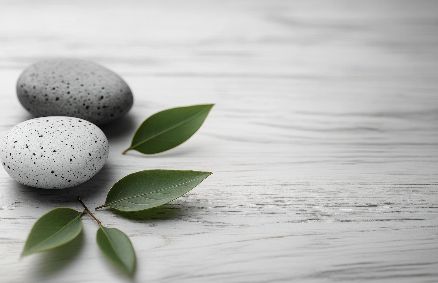 Relaxing stack of smooth stones with a green leaf on a wooden surface for wellness aesthetics photo