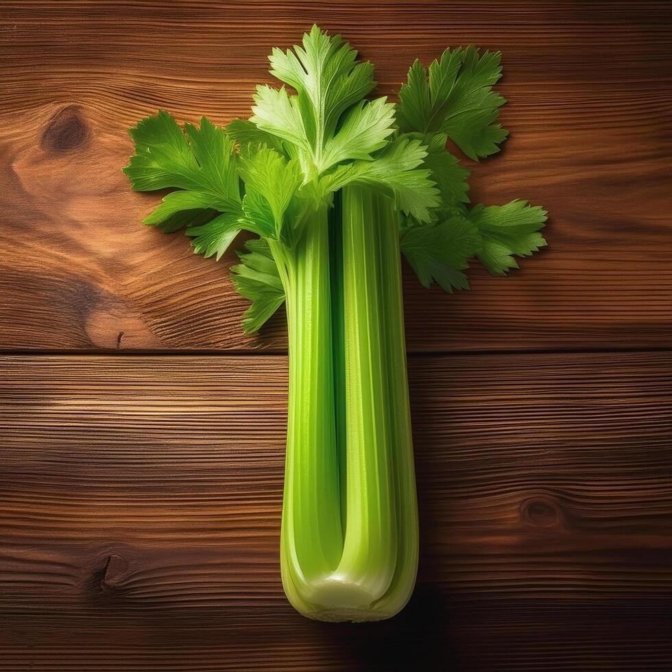 A fresh celery stalk on a wooden brown background photo