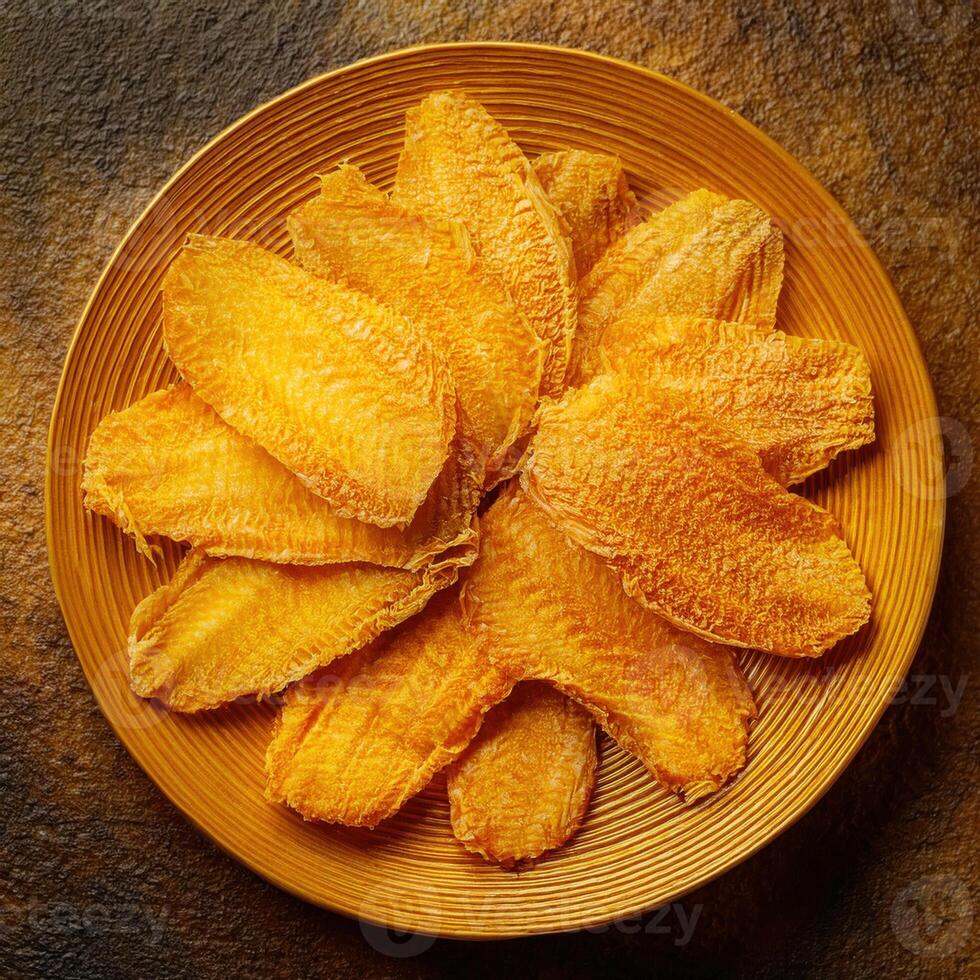 Dried fish on a plate on a dark background photo