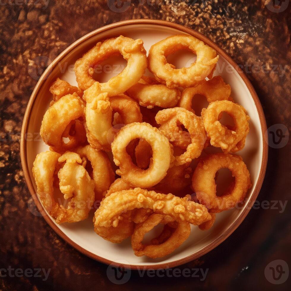 A plate of fried onion rings on a table photo