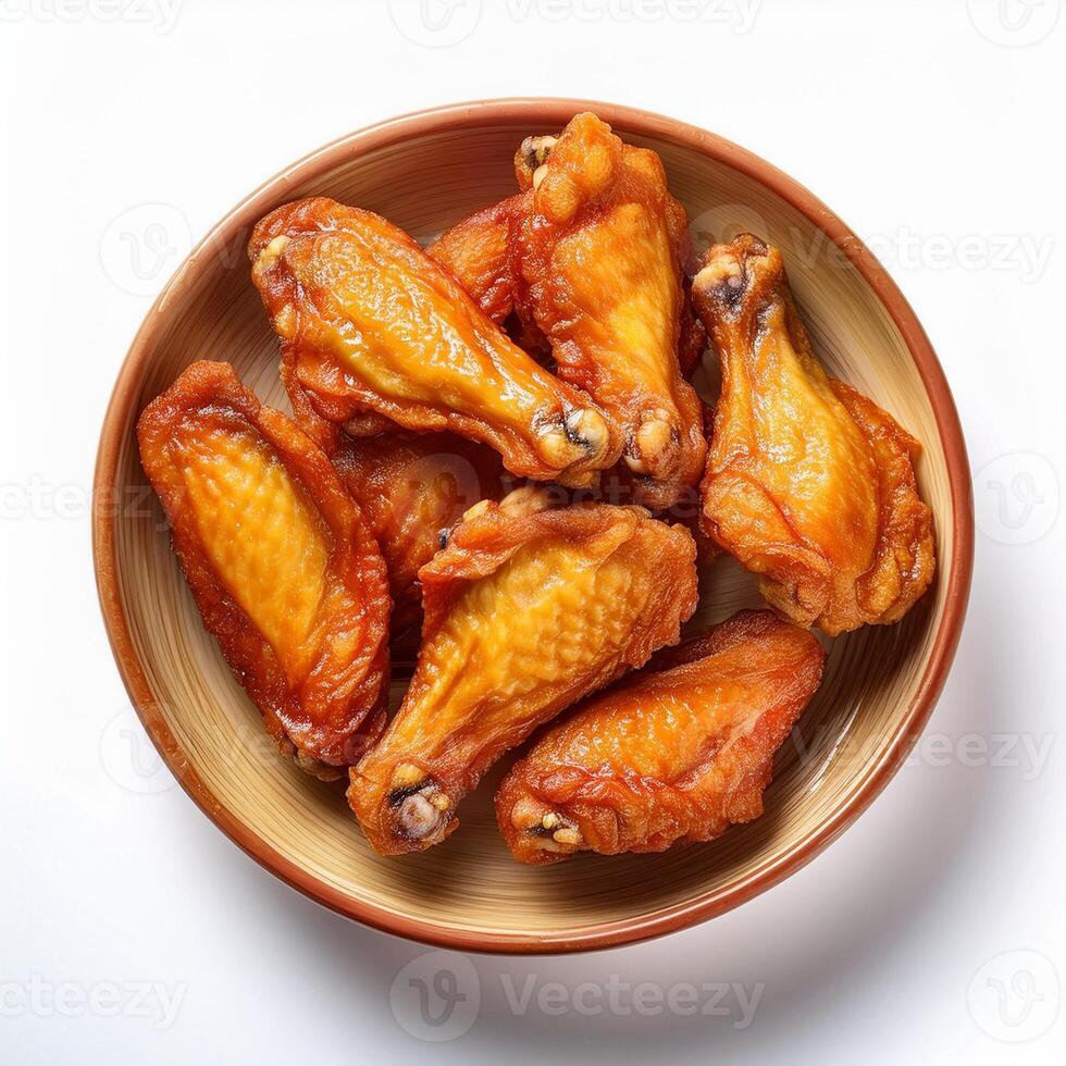 A bowl of fried chicken wings on a white background photo
